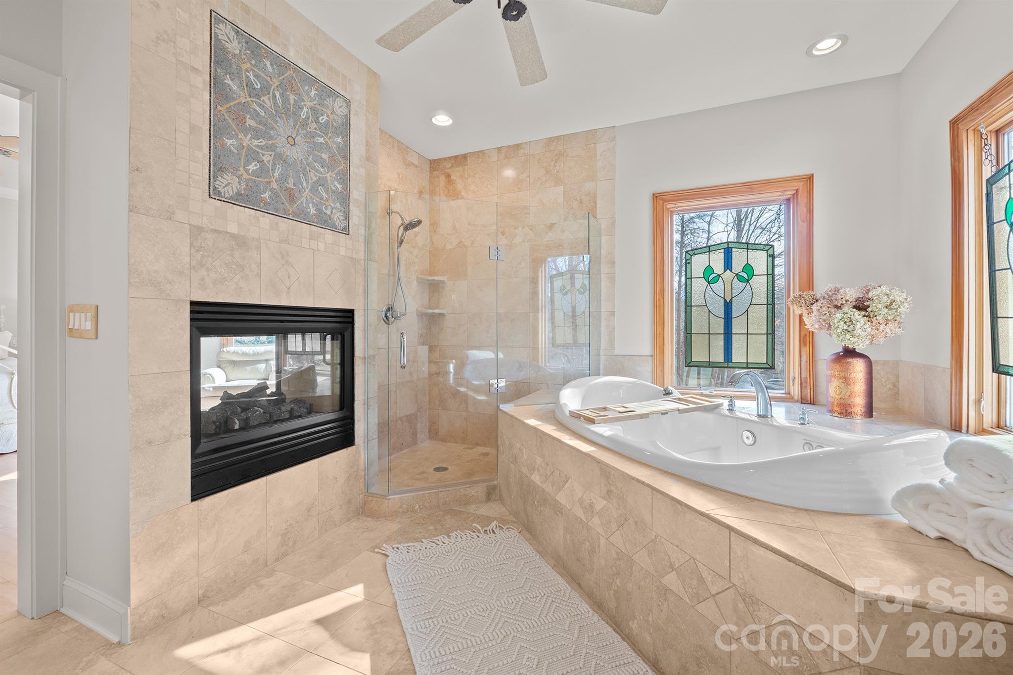 301 Agnew Road Mooresville, NC 28117 - Photo 32 of 42 a spacious bathroom with a granite countertop tub sink a mirror and a shower