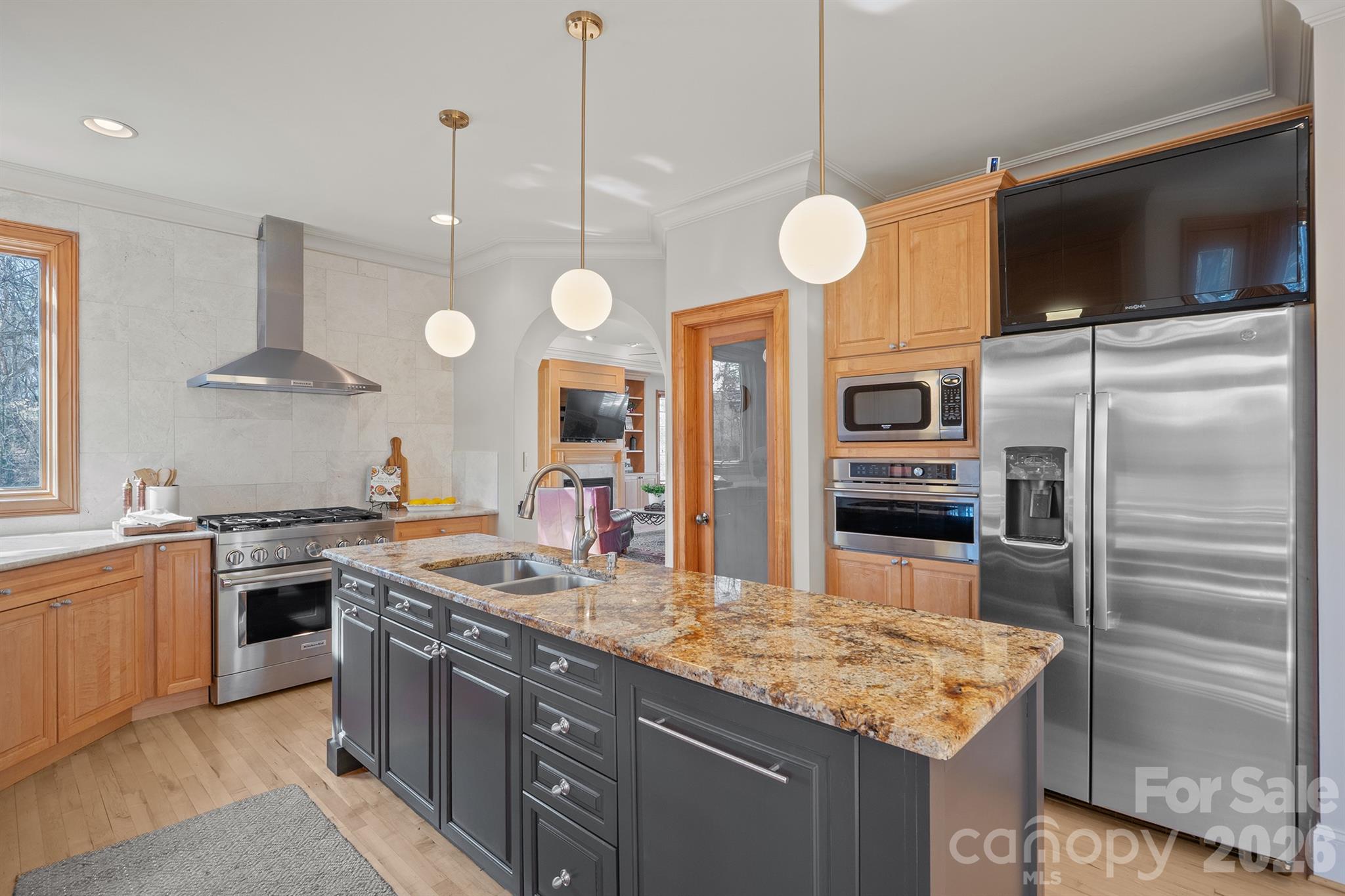 301 Agnew Road Mooresville, NC 28117 - Photo 7 of 42 a kitchen with stainless steel appliances granite countertop a sink a stove and a wooden floors