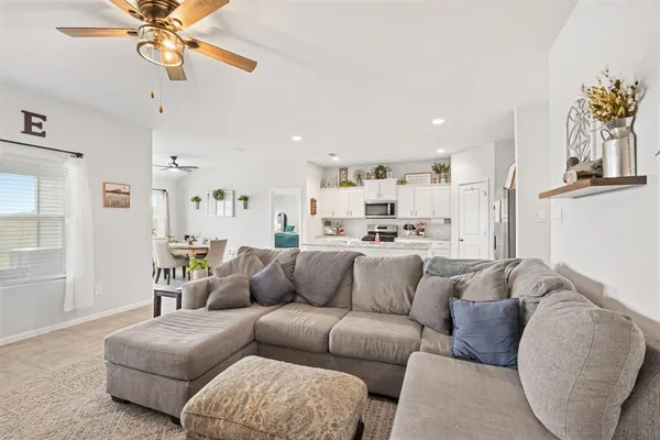 a living room with furniture and kitchen view