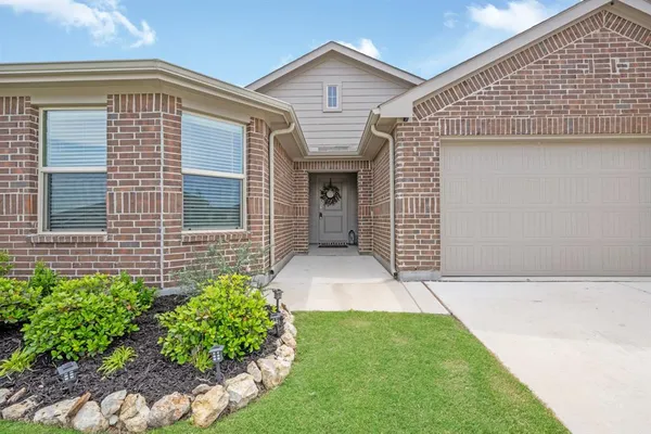 a yellow and red house with a garden