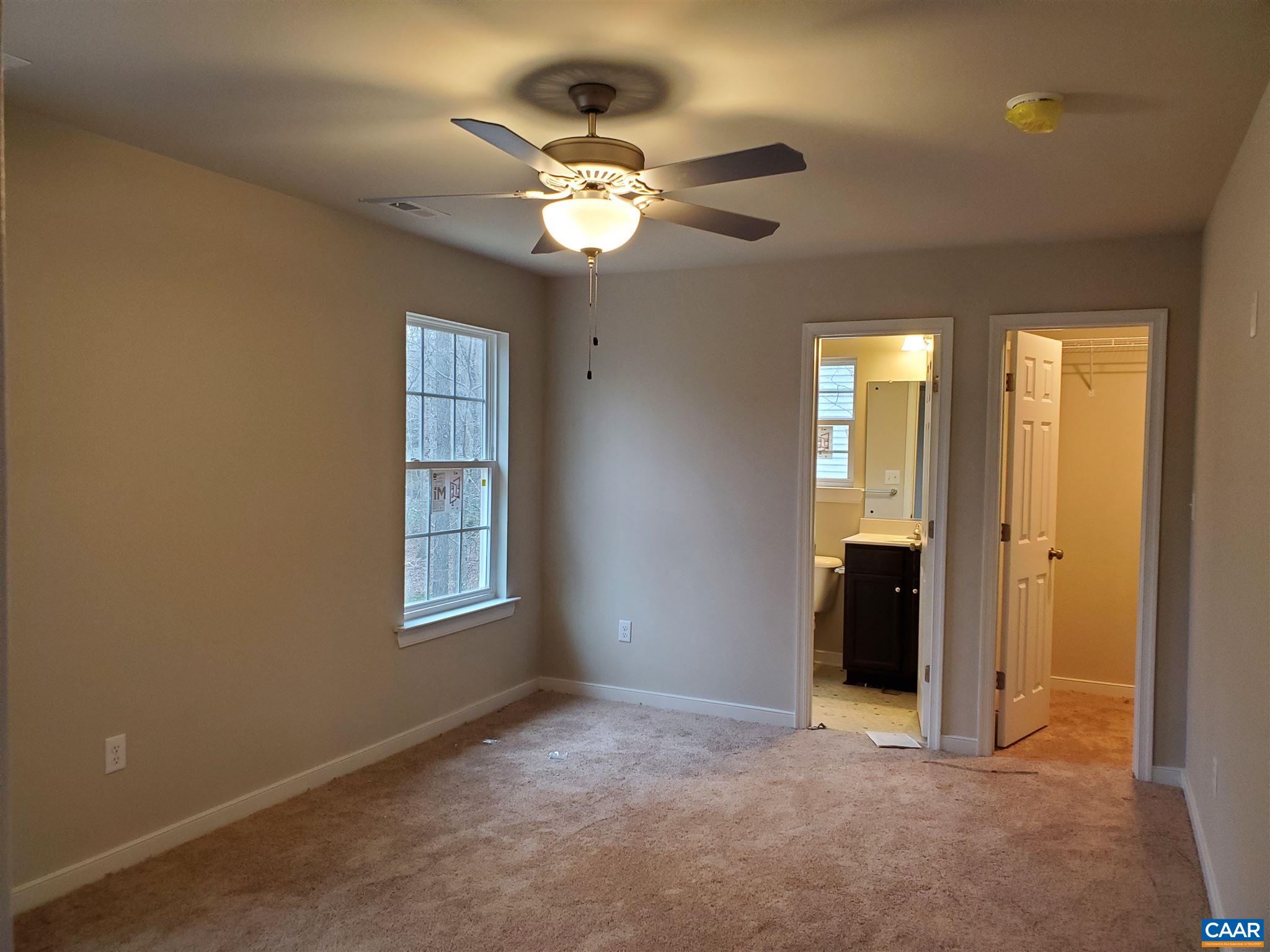 5 Zephyr Road, Unit LOT 268 Palmyra, VA 22963 - Photo 10 of 19 a view of an empty room with a chandelier fan and a window