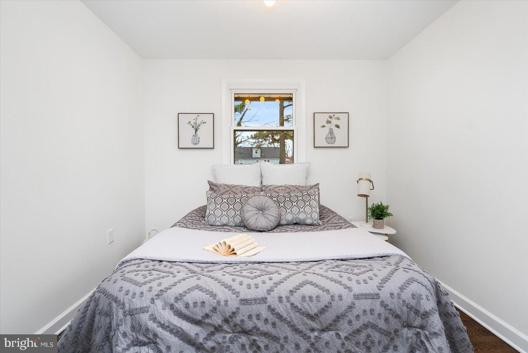 6809 Richardson Road Baltimore, MD 21207 - Photo 16 of 43 a bedroom with a bed and a wall painting