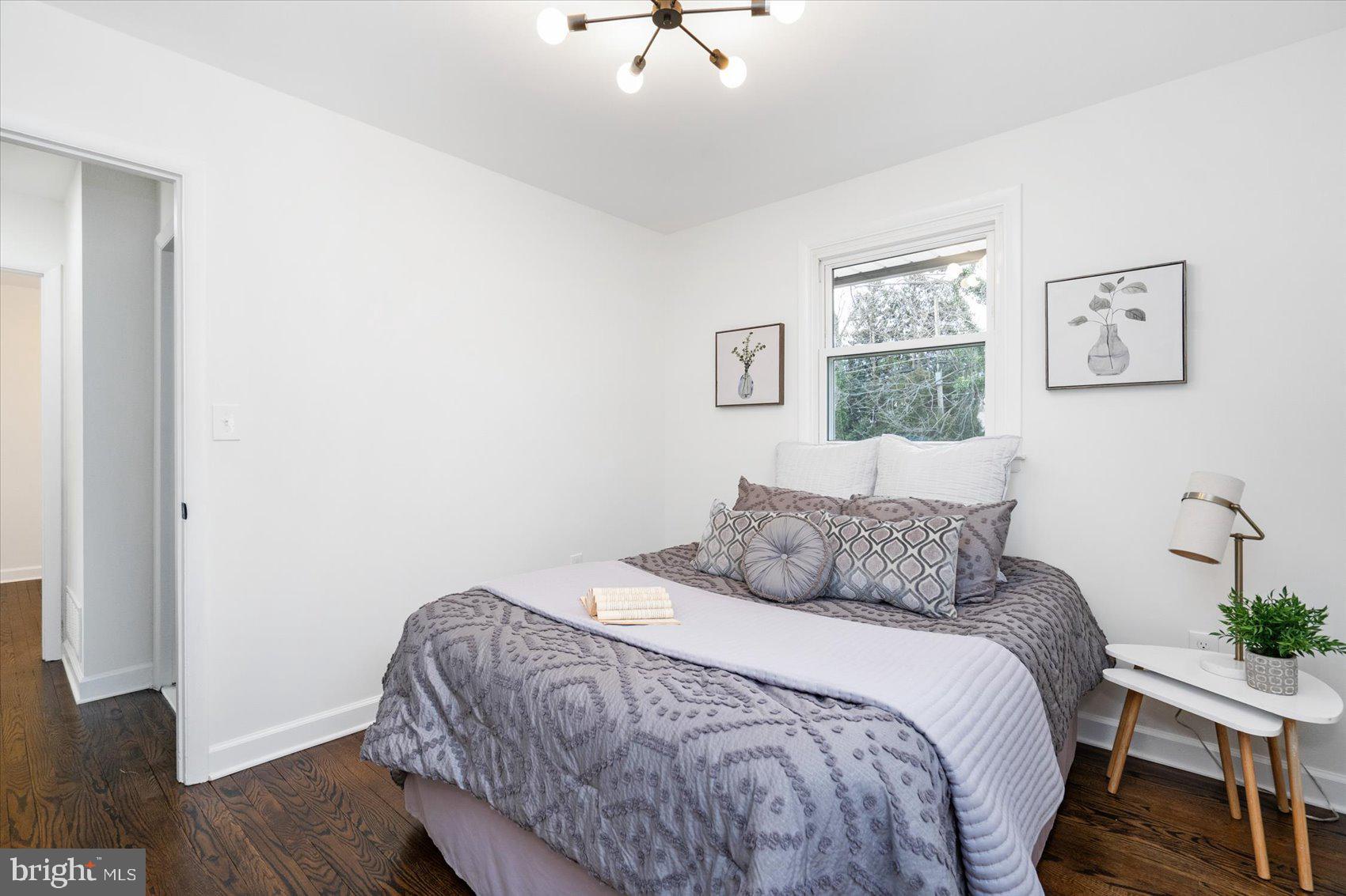 6809 Richardson Road Baltimore, MD 21207 - Photo 17 of 43 a bedroom with a bed and wooden floor