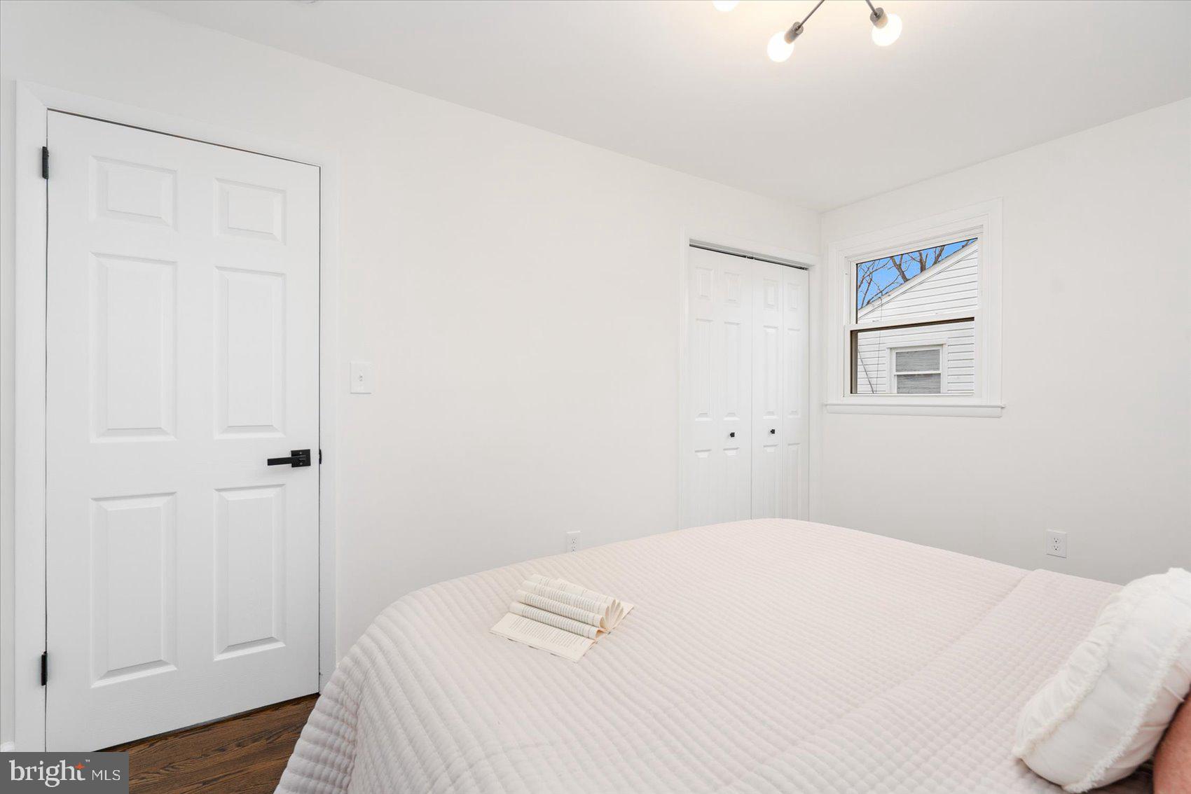 6809 Richardson Road Baltimore, MD 21207 - Photo 21 of 43 a bedroom with a bed and wooden floor