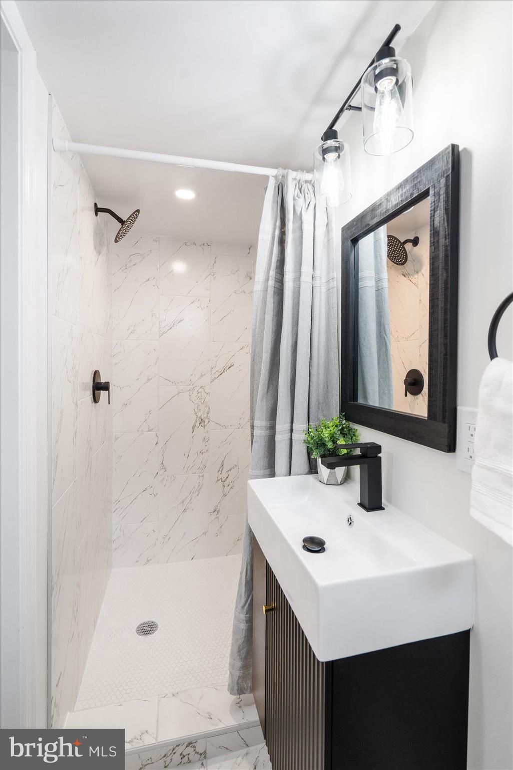 6809 Richardson Road Baltimore, MD 21207 - Photo 34 of 43 a bathroom with a sink and a mirror