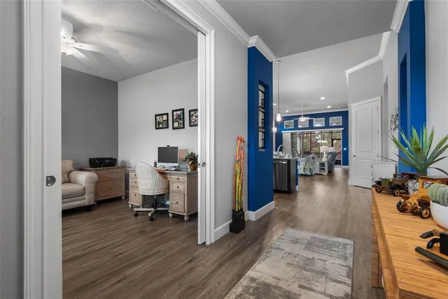 a living room with furniture a flat screen tv and a floor to ceiling window