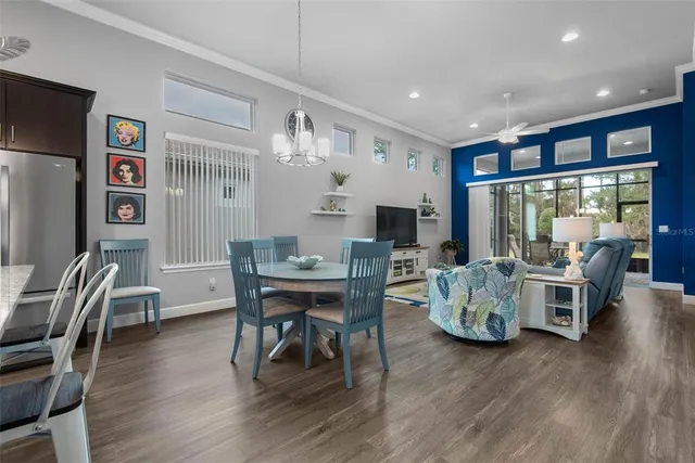 a living room with furniture wooden floor and a large window