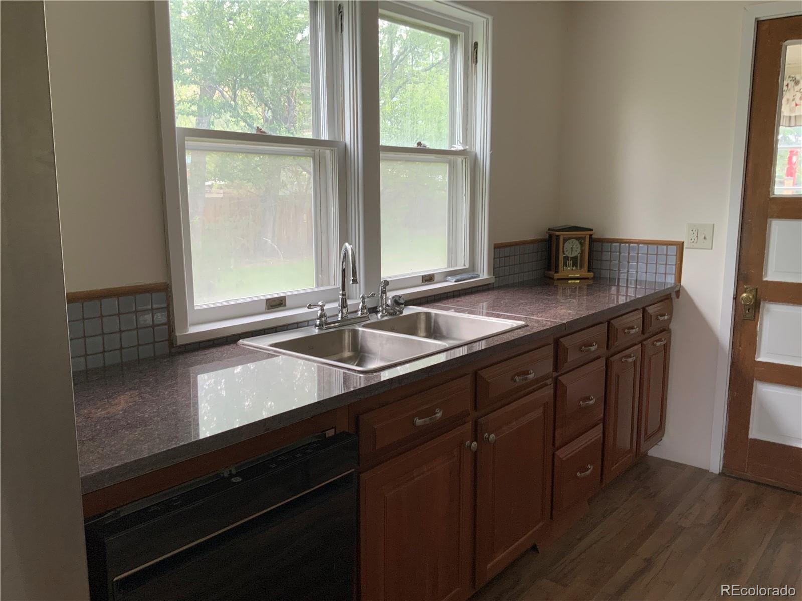 1011 Main Street Meeker, CO 81641 - Photo 2 of 28 a kitchen with a sink a window and cabinets