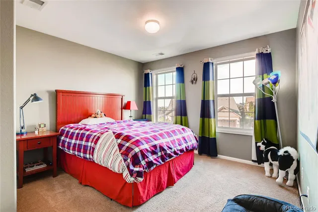 a bedroom with a bed and a flat tv screen