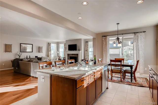 a large kitchen with kitchen island a sink table and chairs