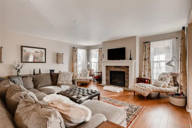 a living room with furniture and a fireplace