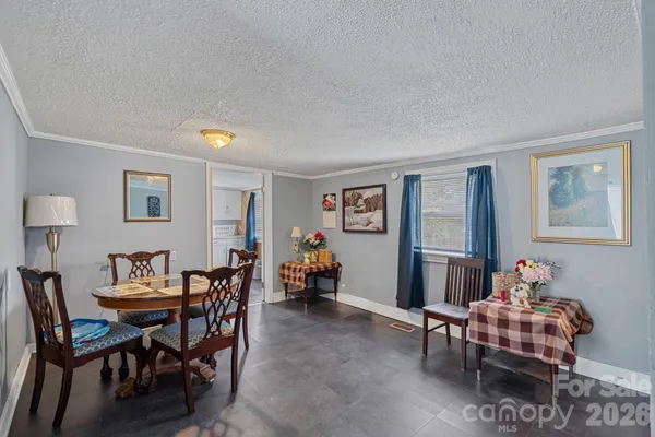 a kitchen with white cabinets and sink