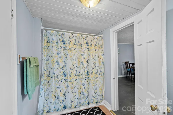 a bedroom with two beds and a chandelier