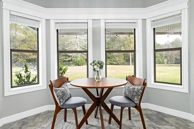 a dining room with furniture window and outside view
