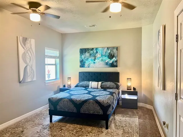 a bedroom with a bed and a chandelier