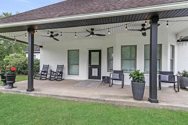 a view of a patio with table and chairs and potted plants