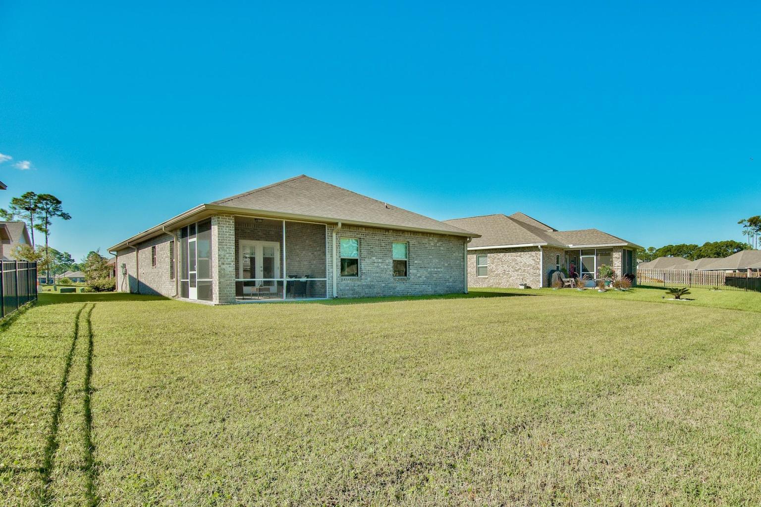 160 Pin Oak Loop Santa Rosa Beach, FL 32459 - Photo 3 of 26 a front view of a house with a garden
