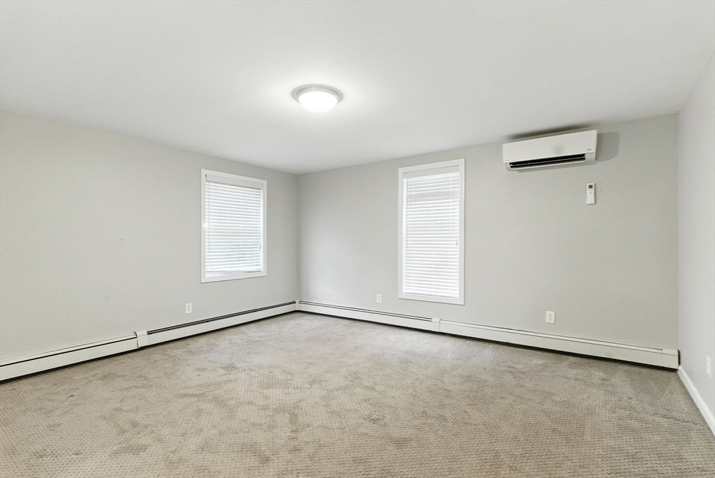 18 Holly Road Holbrook, MA 02343 - Photo 11 of 28 an empty room with a empty space and windows