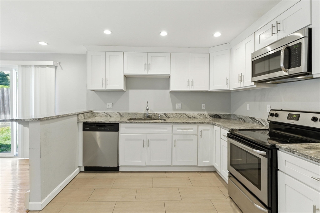 18 Holly Road Holbrook, MA 02343 - Photo 3 of 28 a kitchen with granite countertop white cabinets stainless steel appliances and a window