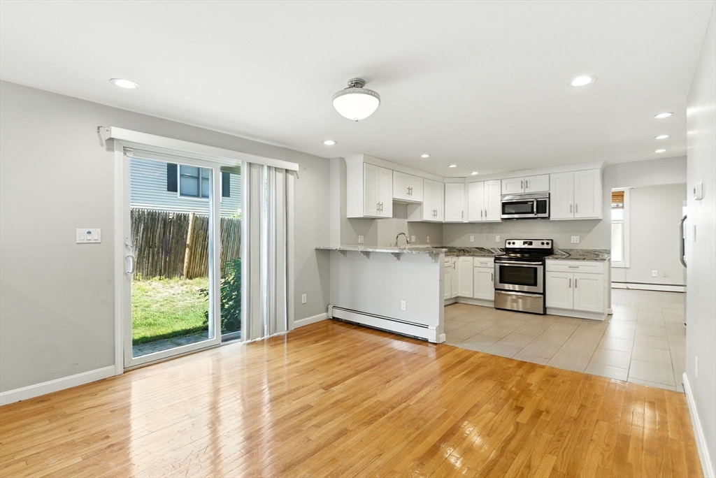 18 Holly Road Holbrook, MA 02343 - Photo 6 of 28 a kitchen with granite countertop a stove a sink and a refrigerator