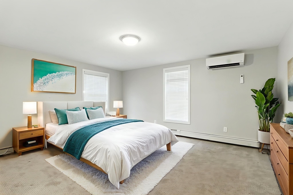 18 Holly Road Holbrook, MA 02343 - Photo 10 of 28 a spacious bedroom with a bed and a potted plant