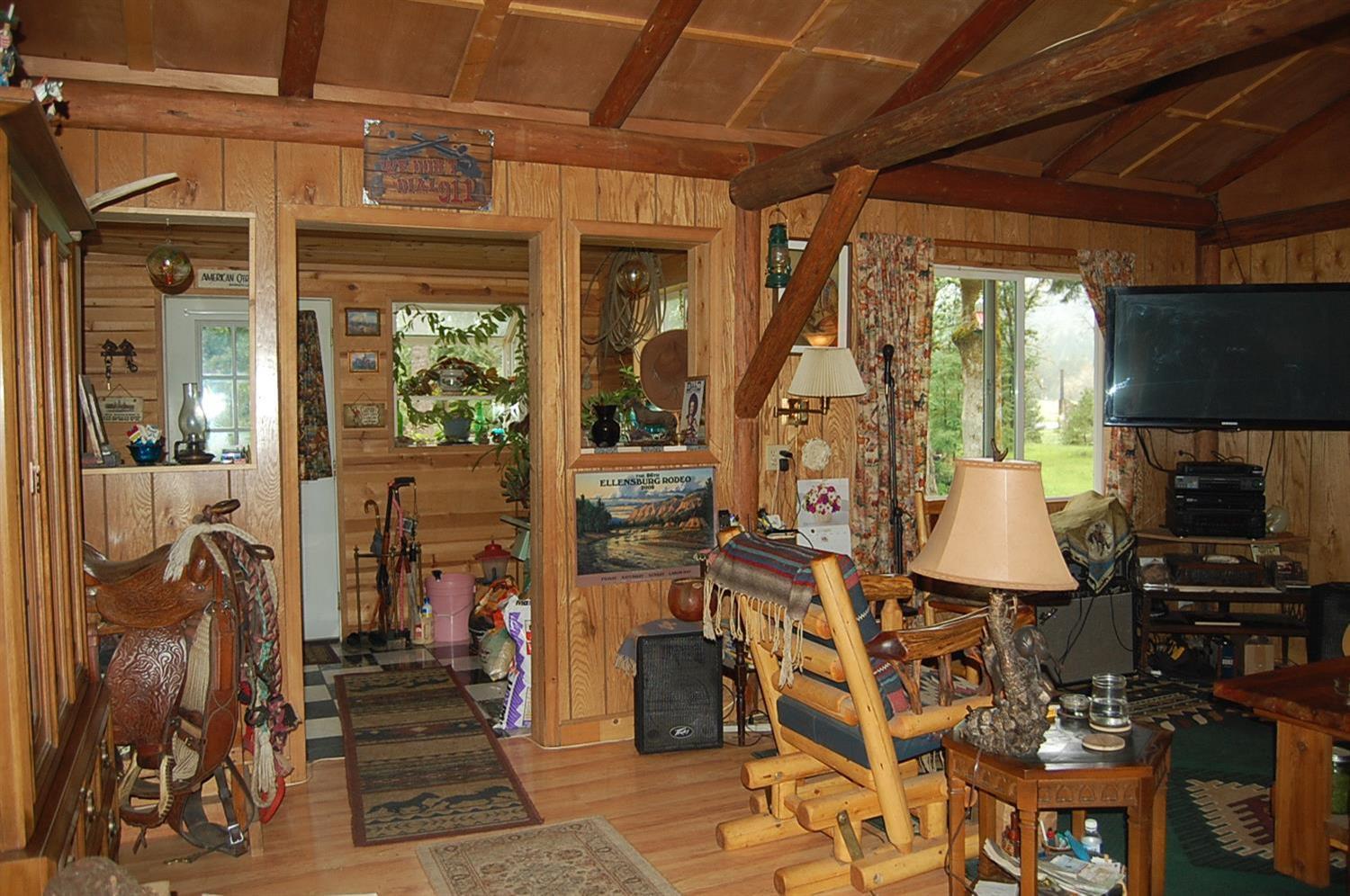 310 Page Creek Road Cave Junction, OR 97523 - Photo 3 of 31 living room with wood paneling