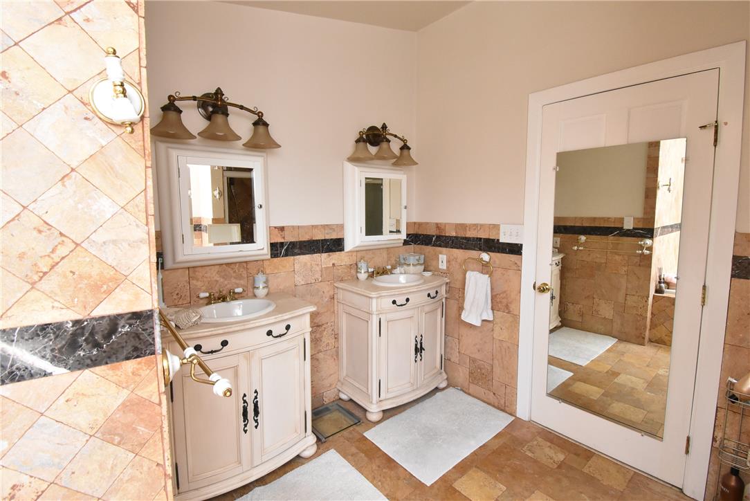 424 Grape Street Whitehall, PA 18052 - Photo 30 of 50 This primary bathroom features dual vanities and tiled walls, creating a clean and functional space.