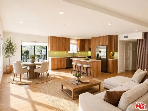 a living room with furniture and a dining table with kitchen view