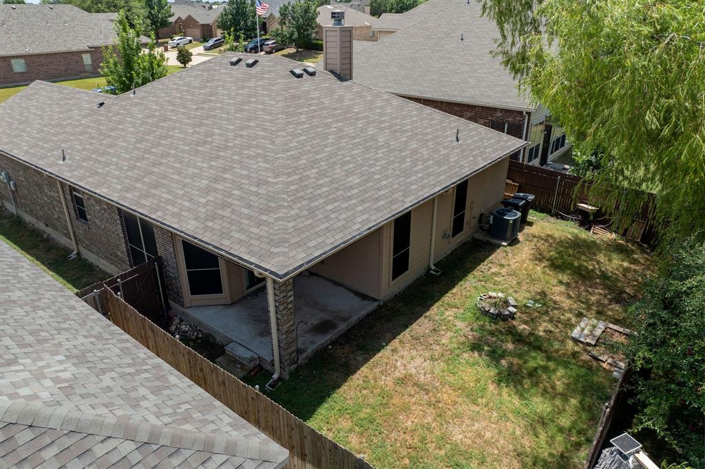 11156 Hawks Landing Road Fort Worth, TX 76052 - Photo 29 of 30 Rear exterior with a covered patio, screens, and a shingle roof