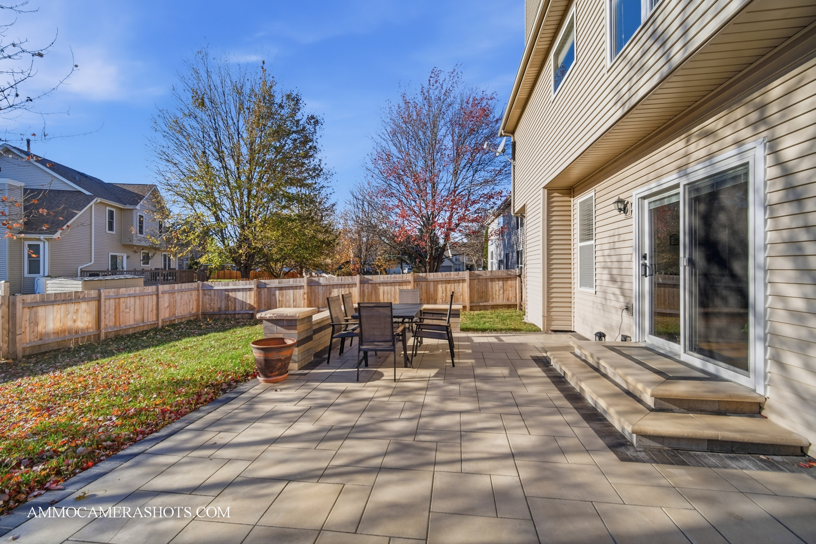 1205 Red Clover Drive Naperville, IL 60564 - Photo 36 of 49 a view of a patio with table and chairs and floor to ceiling window