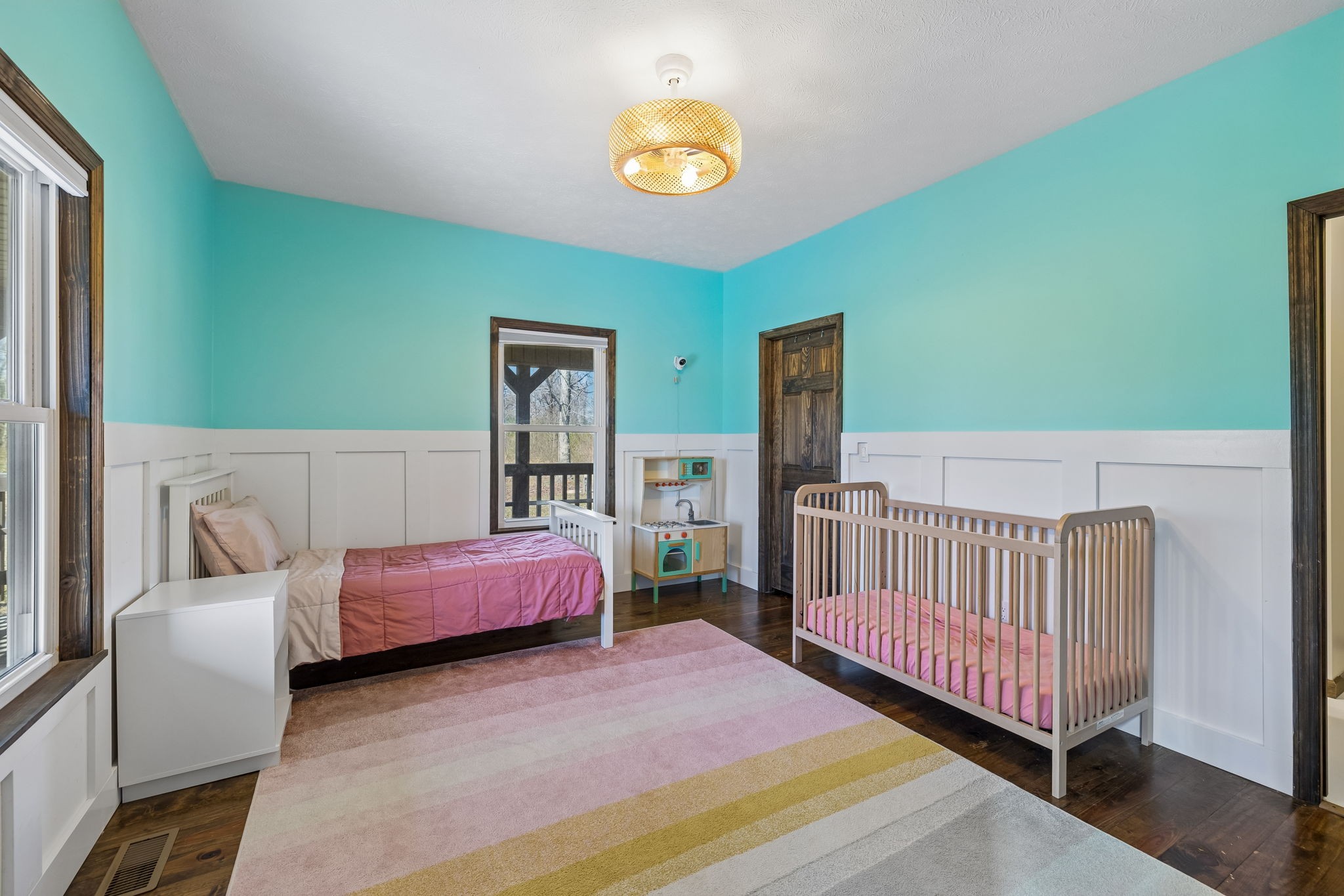 267 Switzerland Road Hohenwald, TN 38462 - Photo 55 of 98 a bedroom with a bed and a chandelier
