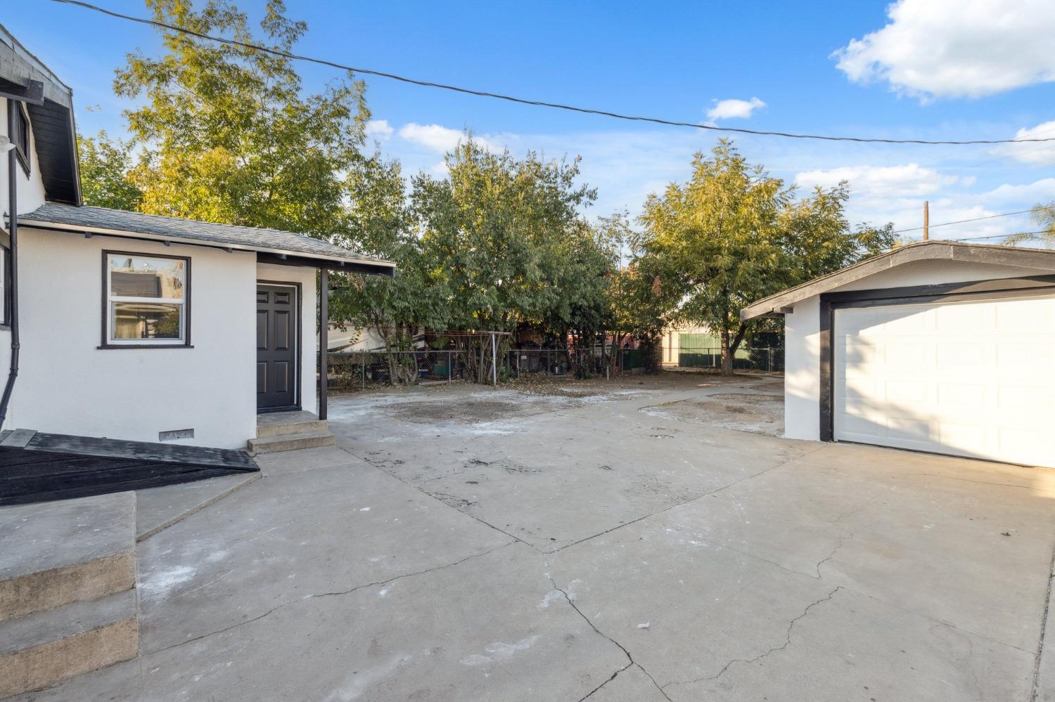 3321 East Montecito Avenue Fresno, CA 93702 - Photo 4 of 22 a view of a house with a backyard and garage