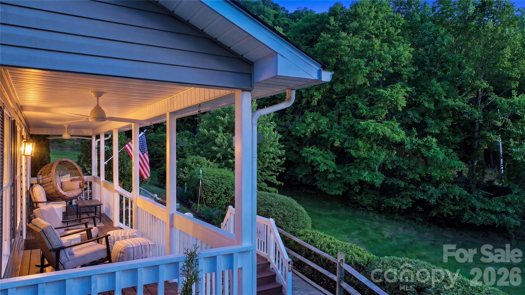 15 Raccoon Point Canton, NC 28716 - Photo 44 of 48 a view of a patio with table and chairs potted plants with wooden floor and fence