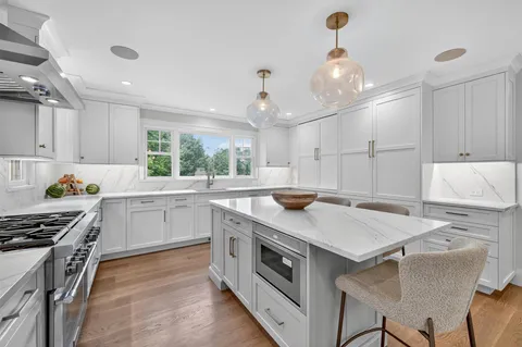 a kitchen with a stove a sink and a refrigerator