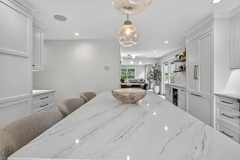 a kitchen with stainless steel appliances kitchen island granite countertop a sink and cabinets