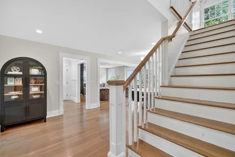 a view of entryway with wooden floor and stairs