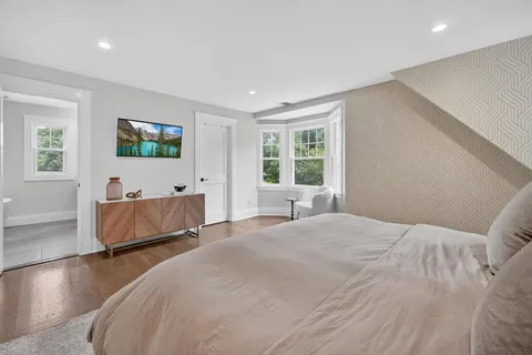 a bedroom with a bed and a flat screen television