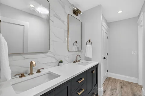 a bathroom with a double vanity sink mirror and double