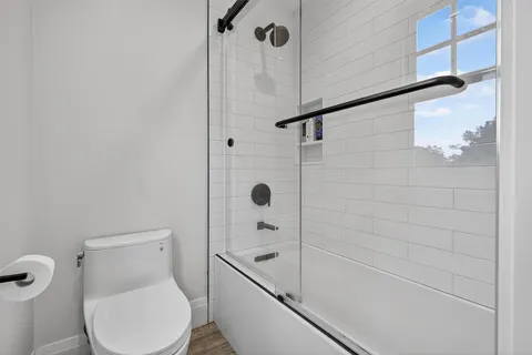 a bathroom with a toilet and shower