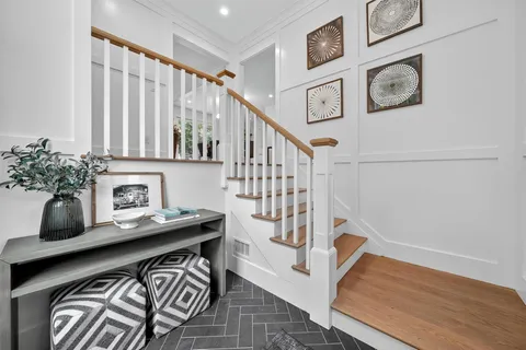 a view of an entryway with wooden floor