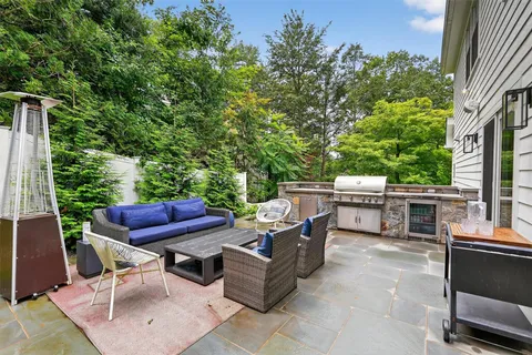 a view of a patio with a dining table and chairs with a fire pit