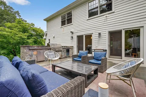 a view of a patio with table and chairs and wooden floor