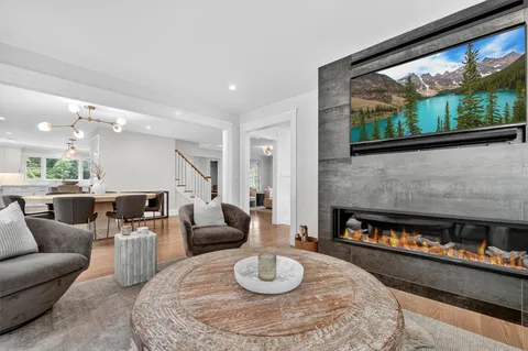 a living room with furniture and a floor to ceiling window