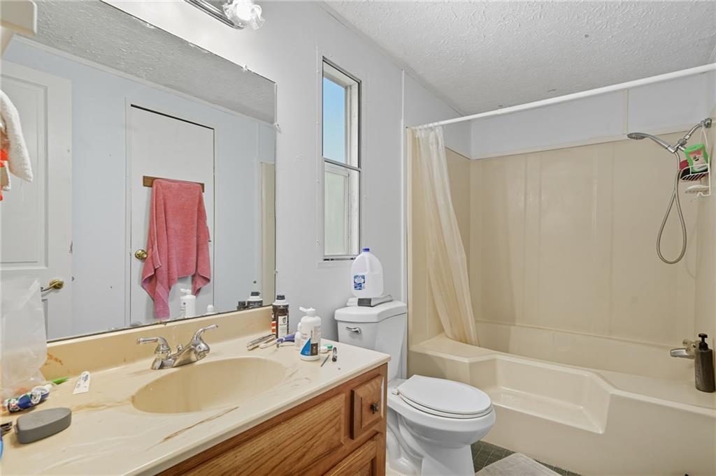 2450 Jones Mountain Road Talking Rock, GA 30175 - Photo 22 of 40 a bathroom with a sink toilet tub and shower