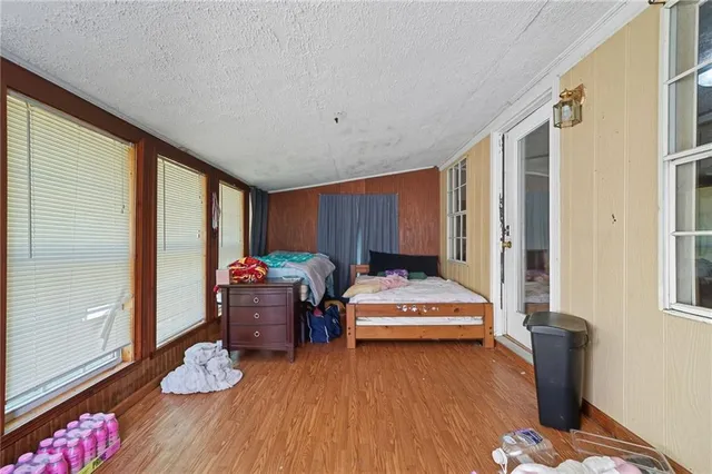 a living room with hard wood flooring and furniture