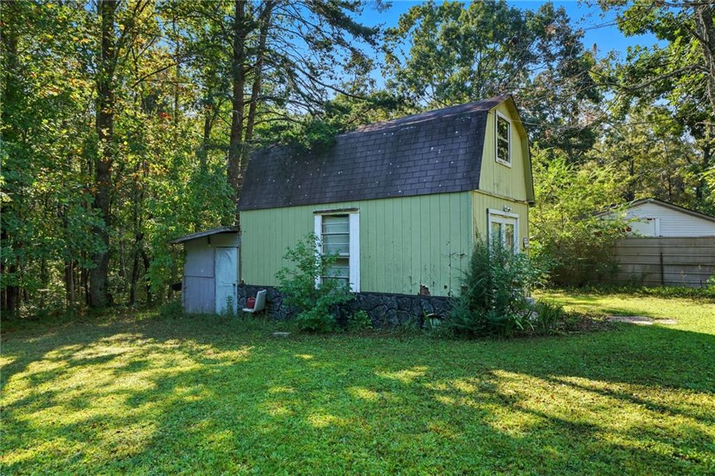 2450 Jones Mountain Road Talking Rock, GA 30175 - Photo 36 of 40 a view of a backyard with potted plants and large tree
