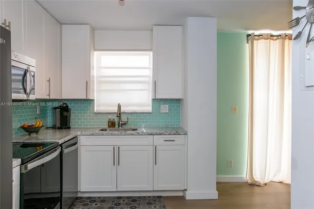 a white toilet sitting next to a white sink