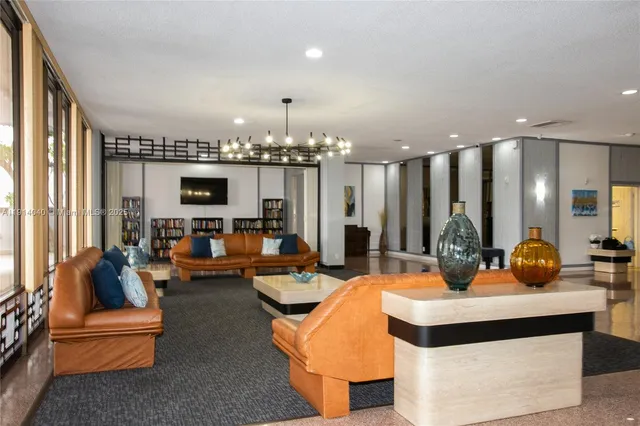 a living room with patio furniture and a fireplace