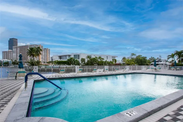 a view of swimming pool with outdoor seating and lake view