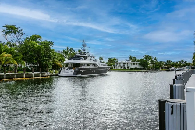 a view of a white building with a small yard